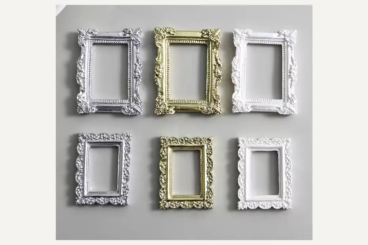 Six small ornate picture frames in white, silver and gold finishes