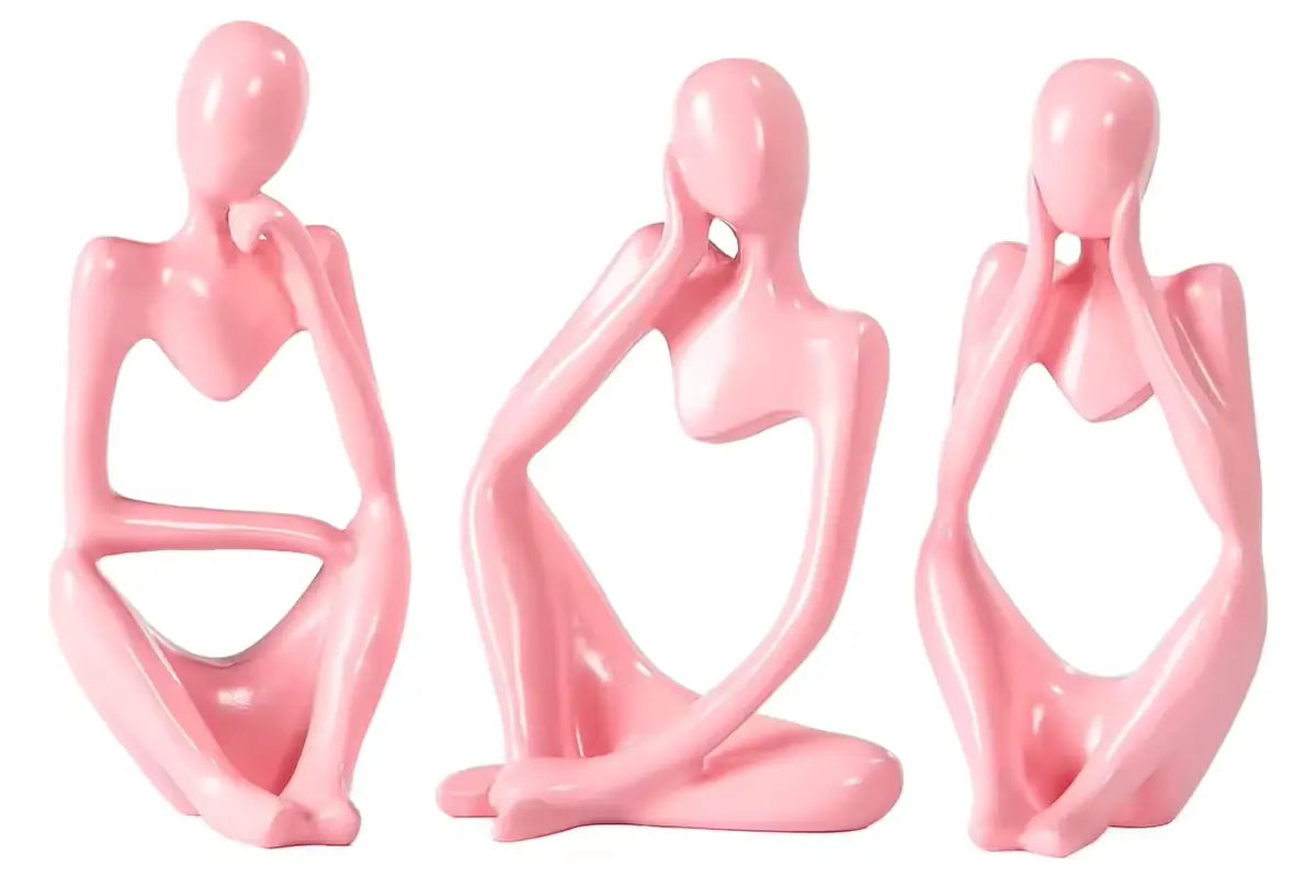 Three glossy pink abstract seated figurines in matching color