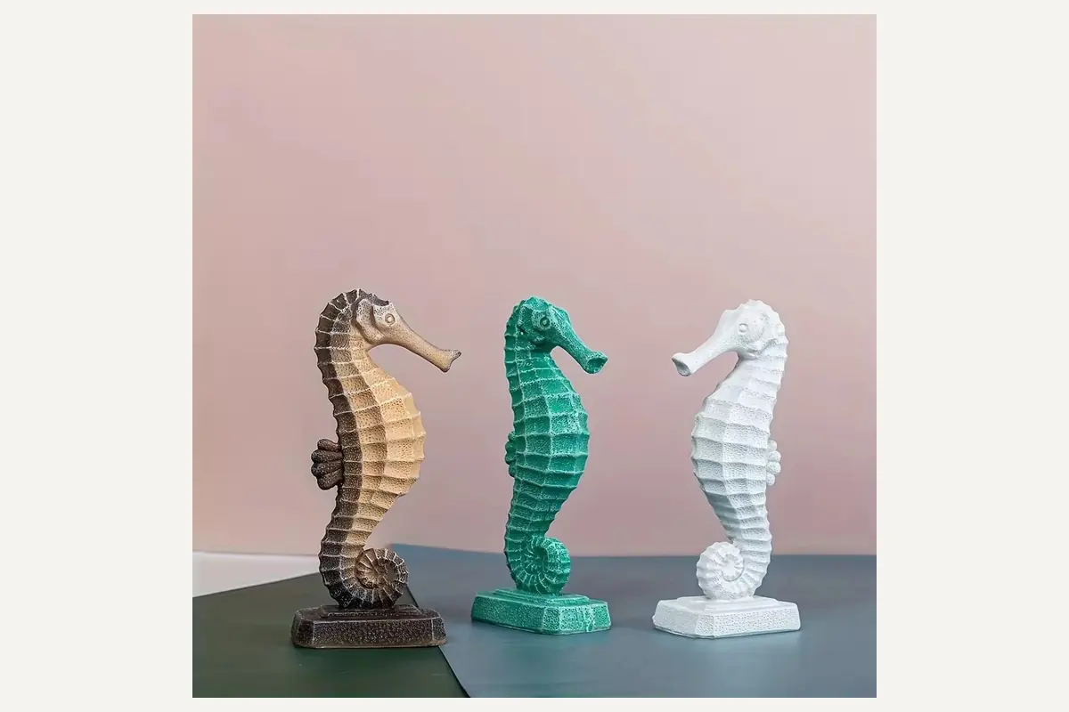 Three seahorse figurines in brown, green and white