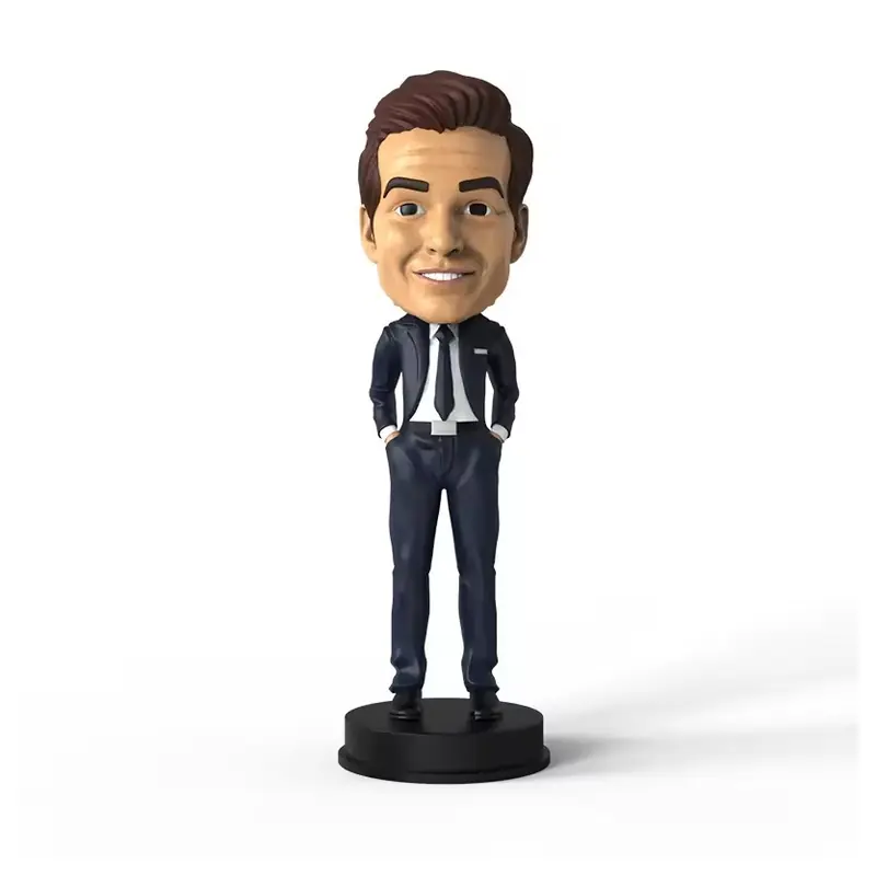 A suited business character bobblehead on a round black base
