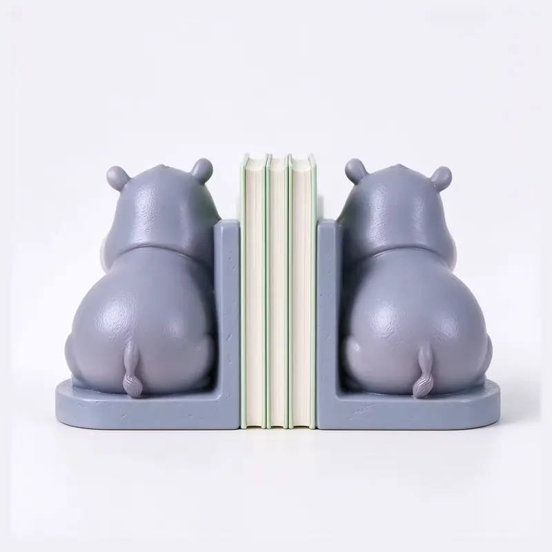 Purple hippopotamus bookends arranged on either side of books