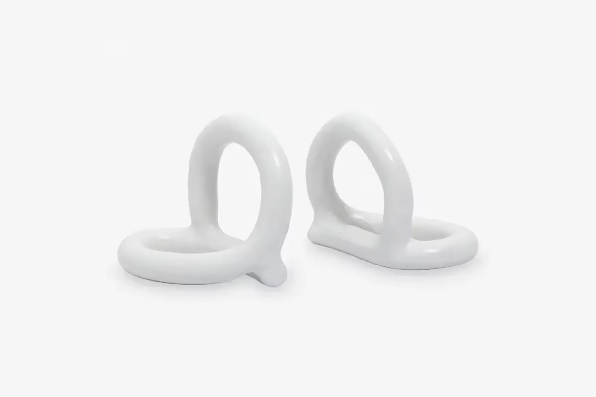 Two ivory abstract bookends with curved bodies and broad lower plates
