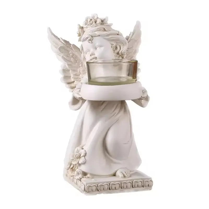 An ivory angel figure holding a separate empty glass cup