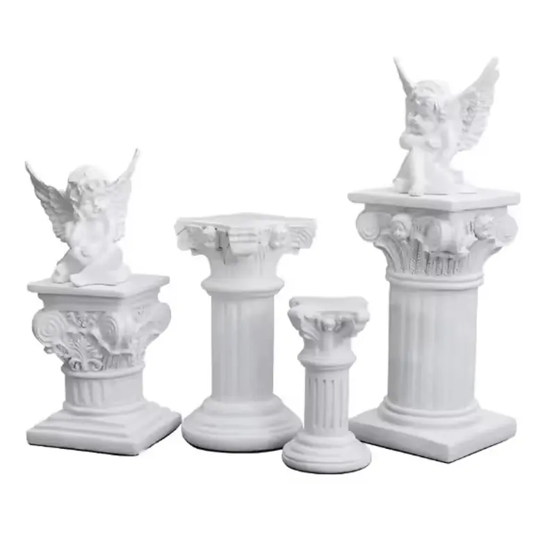 Ivory column pedestals with fluted shafts and seated angel figures