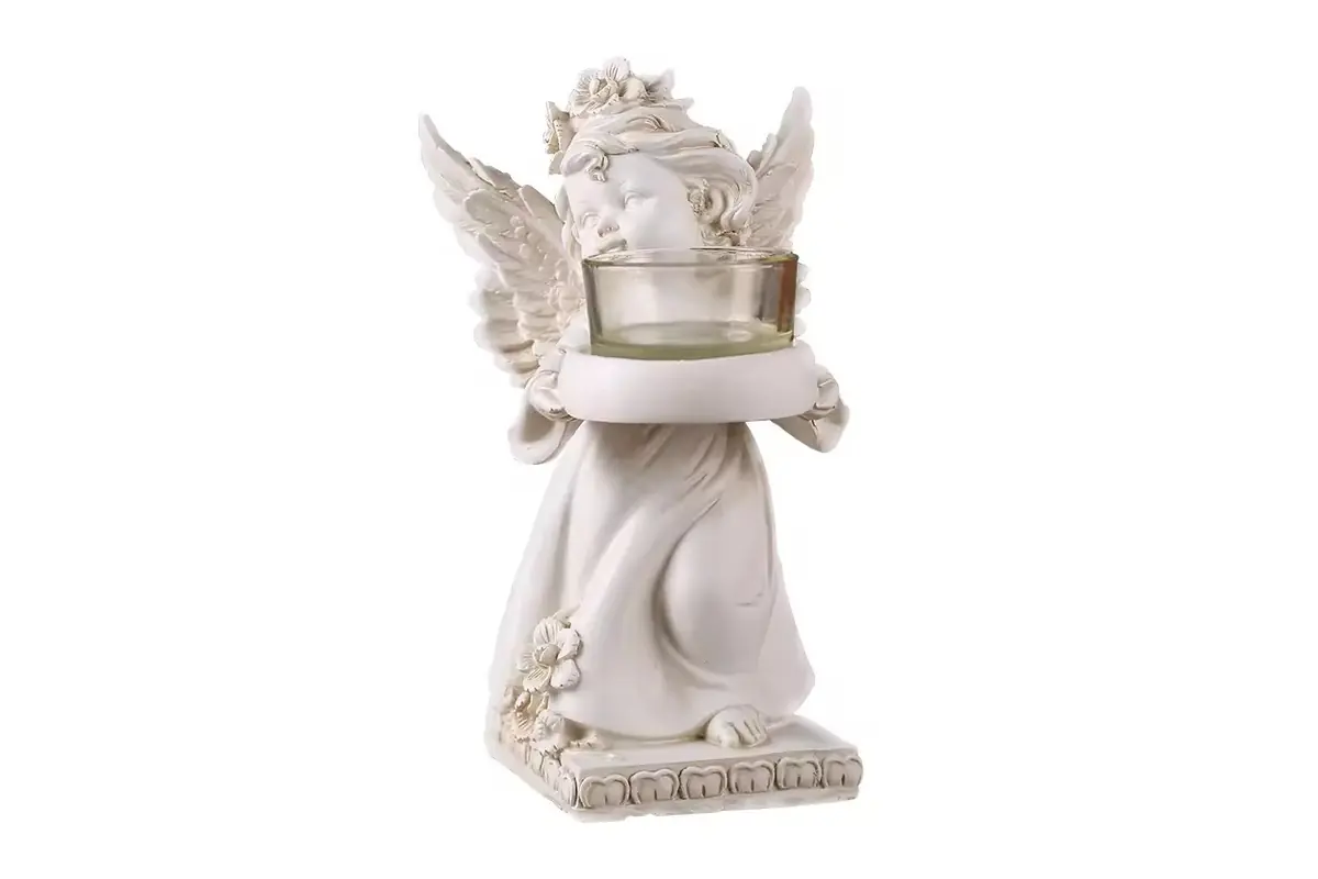 An ivory angel candle holder with a raised circular cup