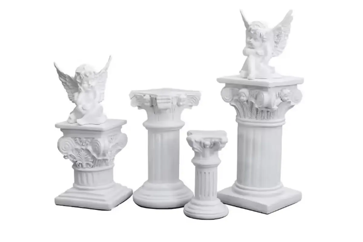 Ivory column and angel candle holders with sculpted relief and broad bases