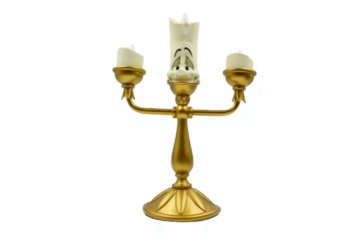 A gold-colored three-arm candle holder with separate upright cups