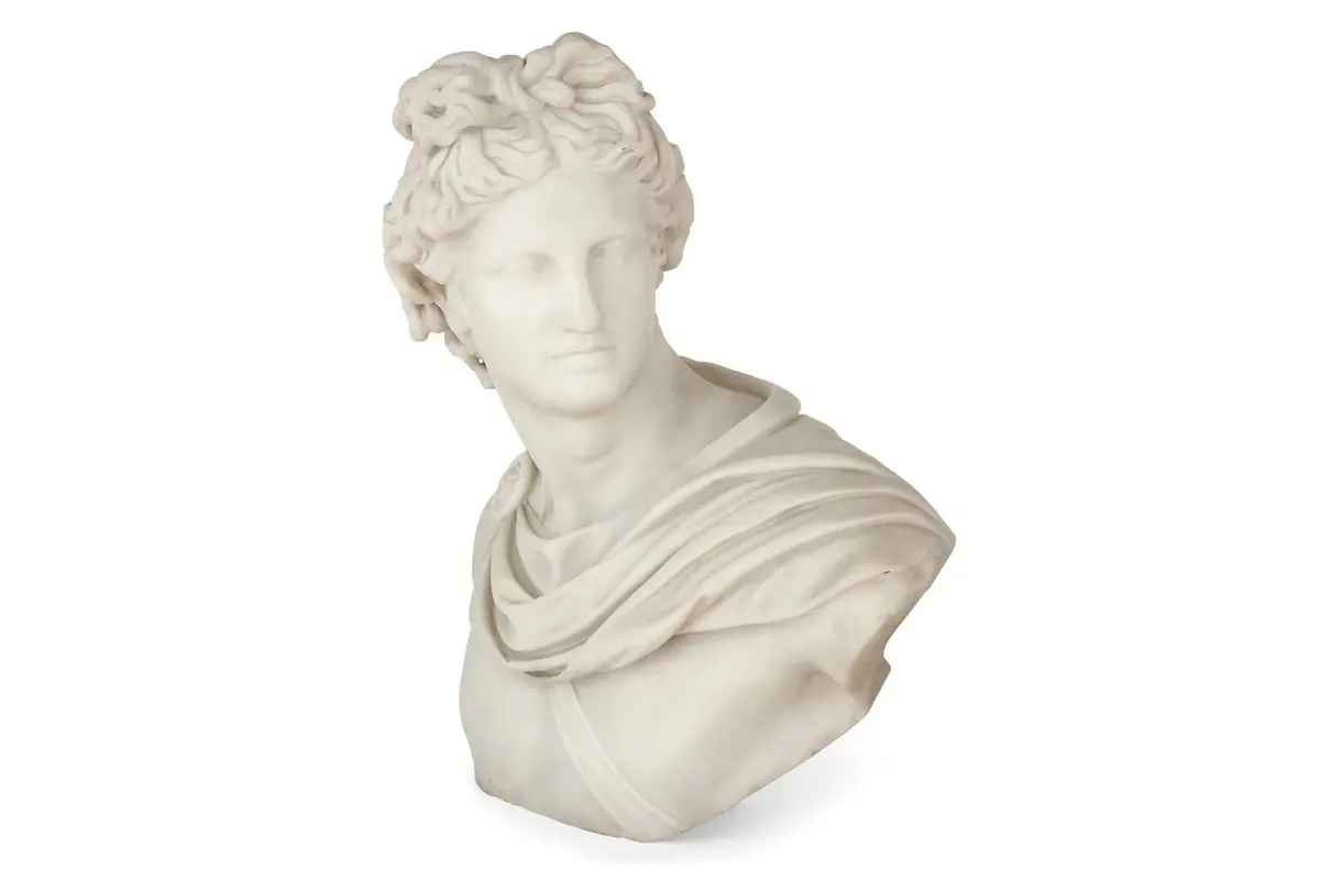 A white classical bust with detailed curly hair