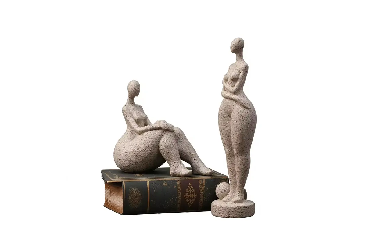 Seated and standing female sculptures with textured stone-like surfaces