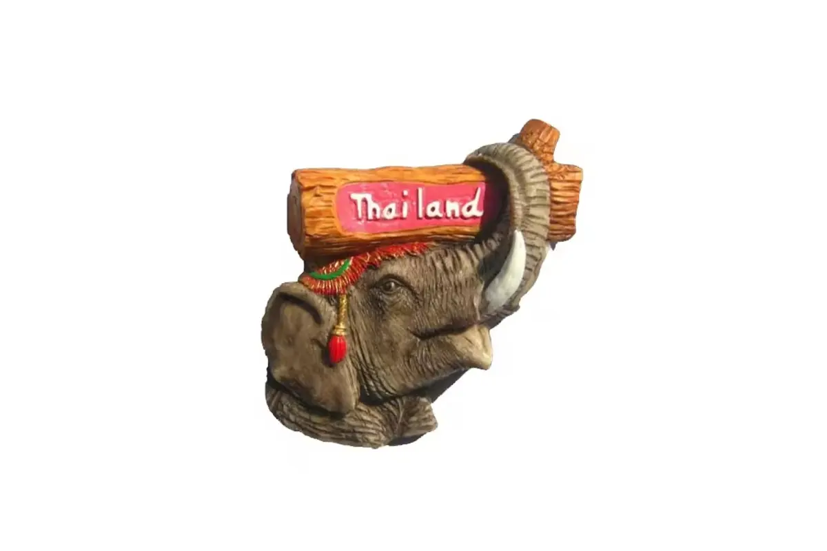An elephant-shaped Thailand souvenir magnet with a raised name band