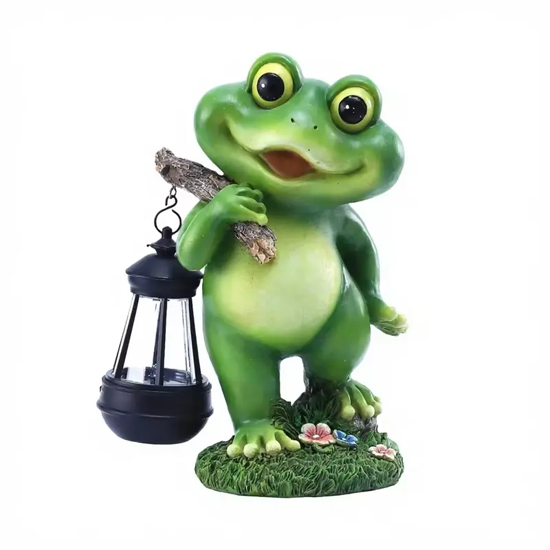 A green frog garden statue holding a separate black lantern