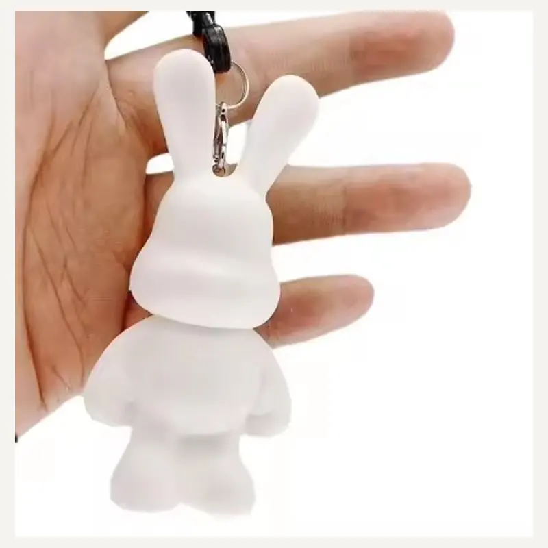 An unpainted long-eared rabbit-shaped keychain with a top connector and black strap