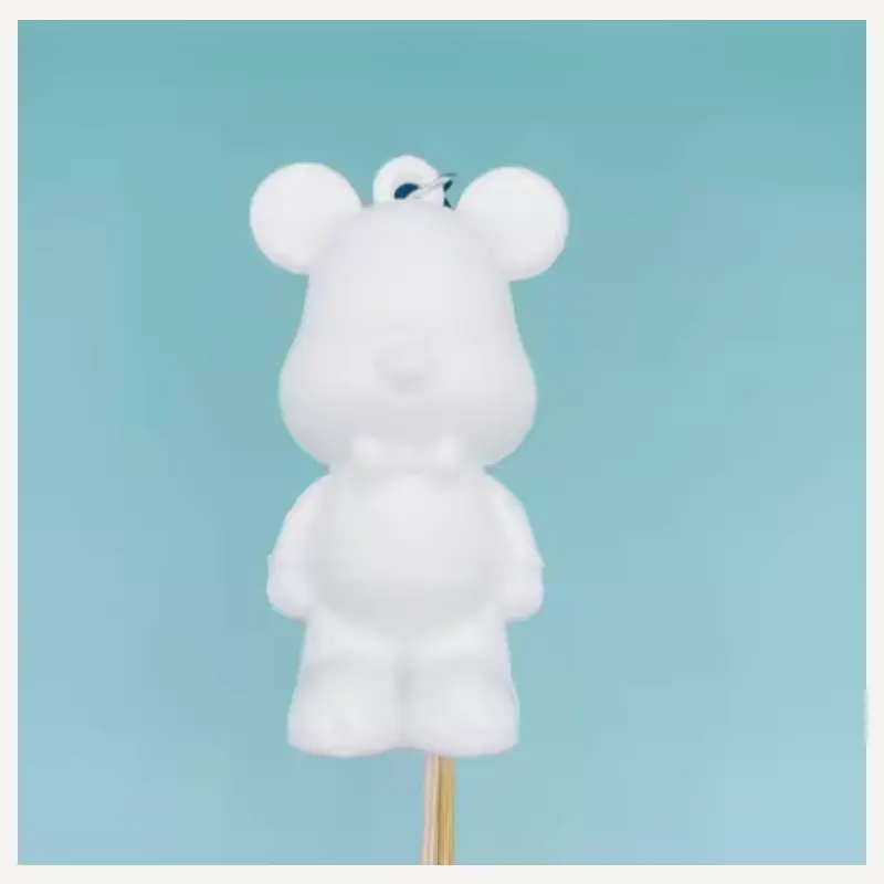 An unpainted mouse-like character charm with circular ears, a broad muzzle and a sculpted outfit