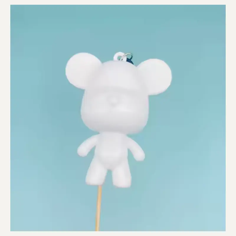 An unpainted mouse-like character charm with circular ears, a cap and shorts