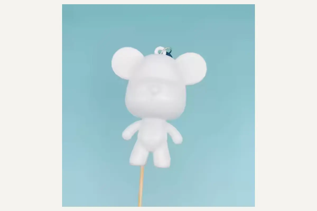 Unpainted round-eared animal keychain wearing a cap and shorts