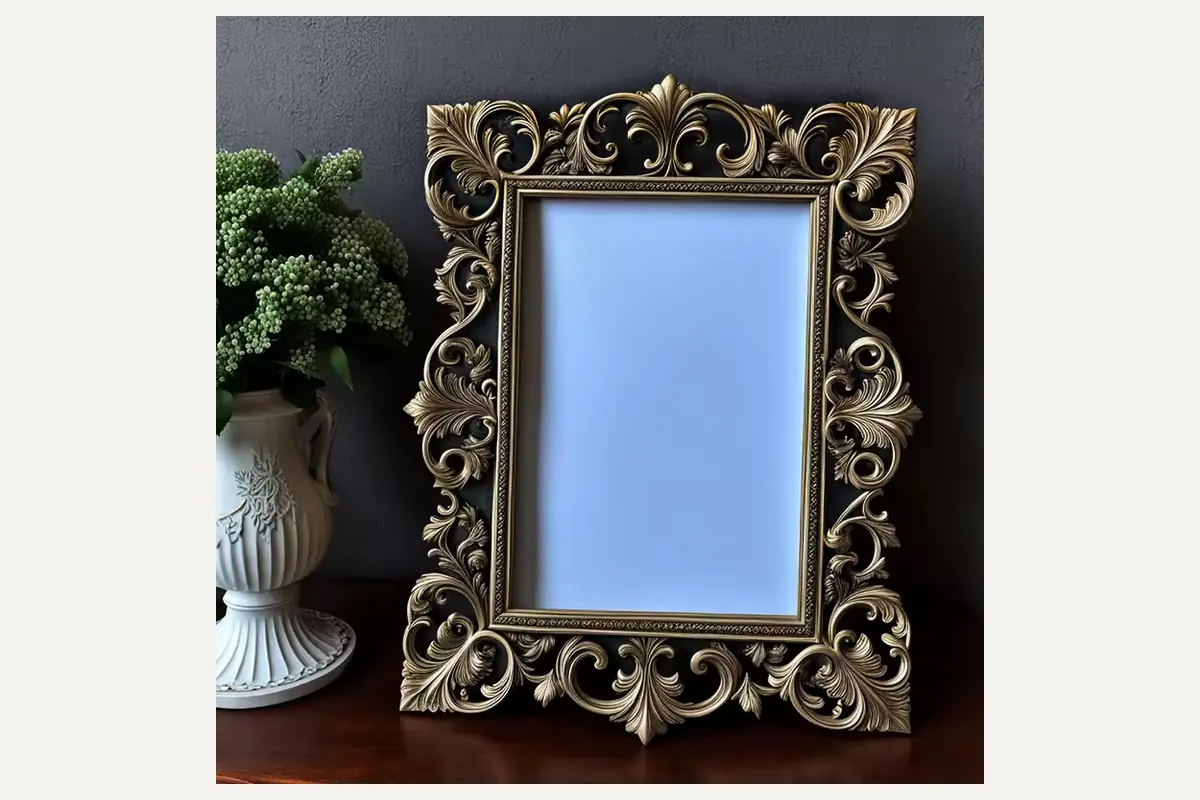 An ornate rectangular photo frame with raised scrolling leaves