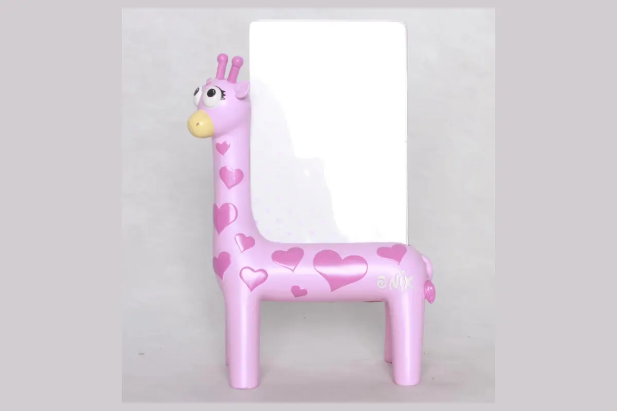A pink giraffe-shaped photo frame with a small picture opening