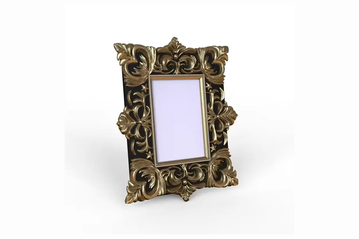 A small dark antique-style rectangular photo frame with sculpted borders