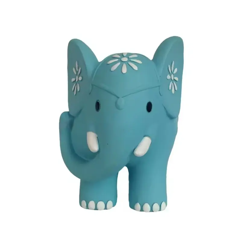 A teal elephant coin bank with white floral patterns