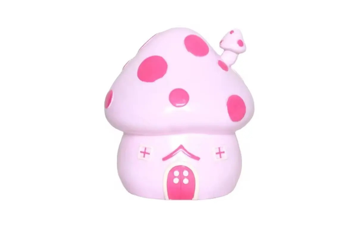 A pink mushroom-house coin bank with raised windows and a door
