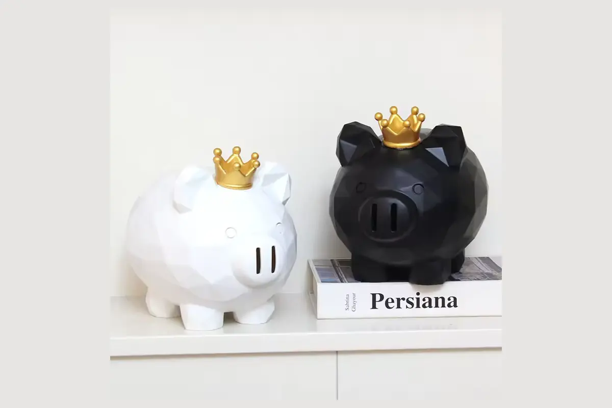Black and white faceted pig coin banks with gold-colored crowns