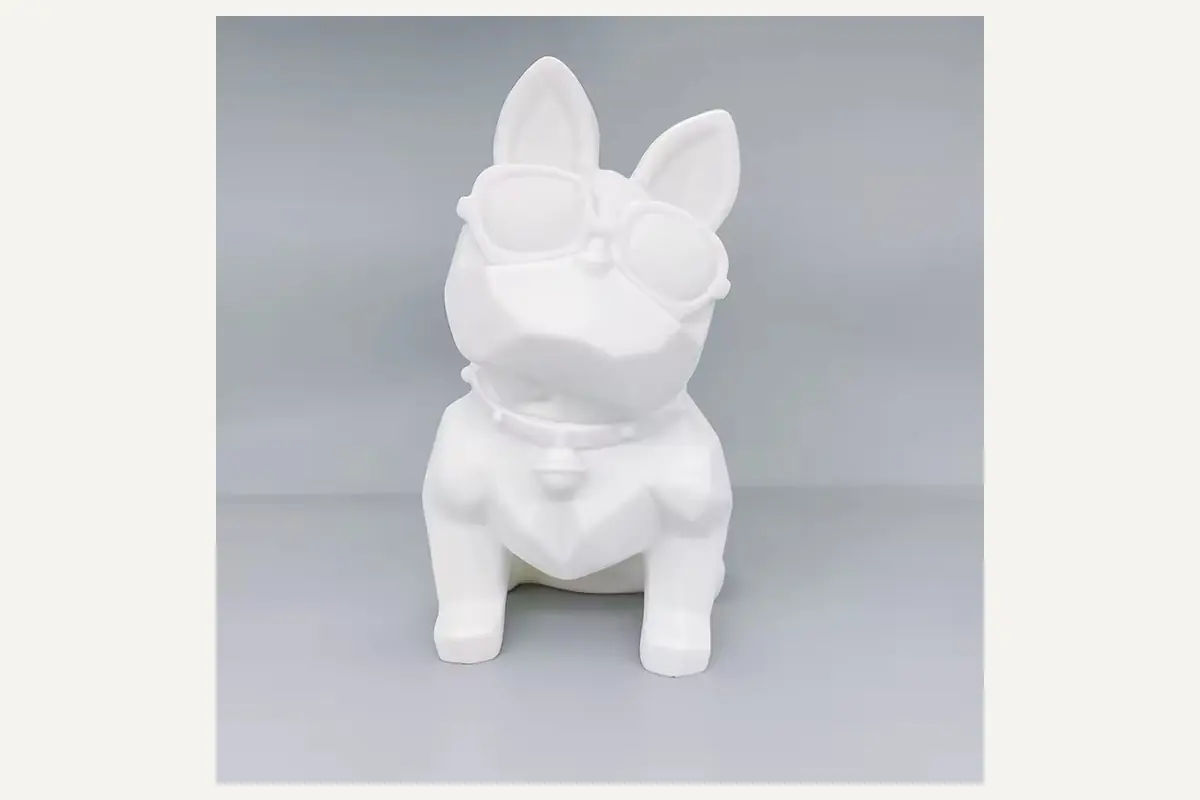 A white faceted bulldog-shaped coin-bank blank
