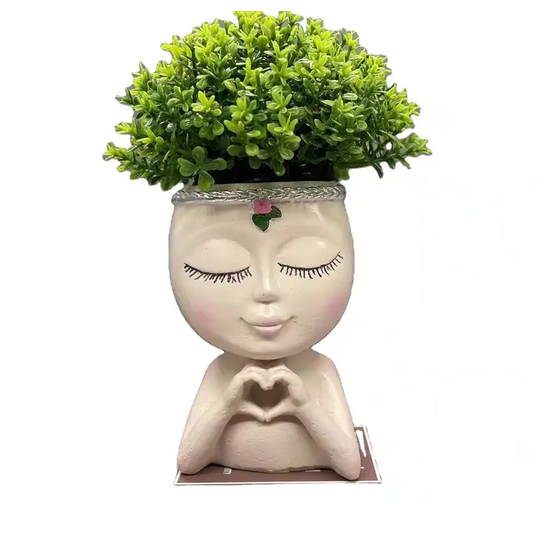 A girl-shaped planter with closed eyes and hands forming a heart