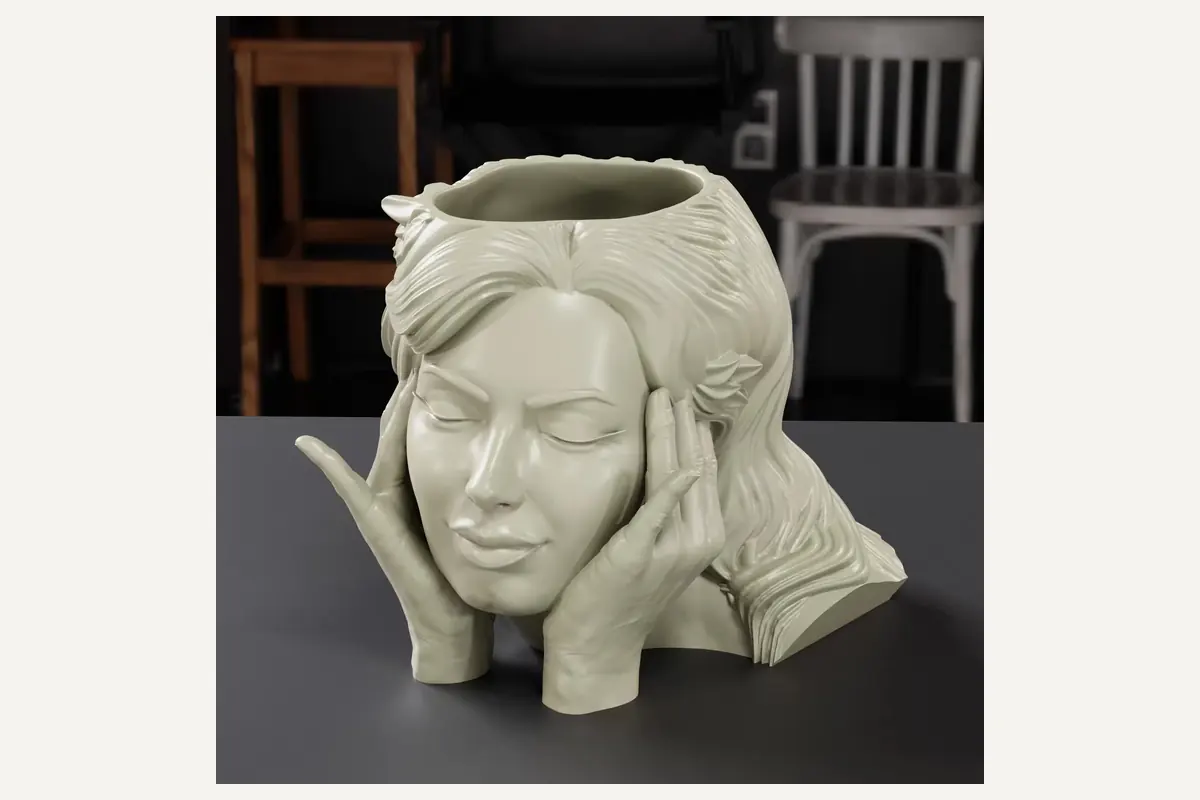 An empty woman-face planter with an open top and sculpted hair