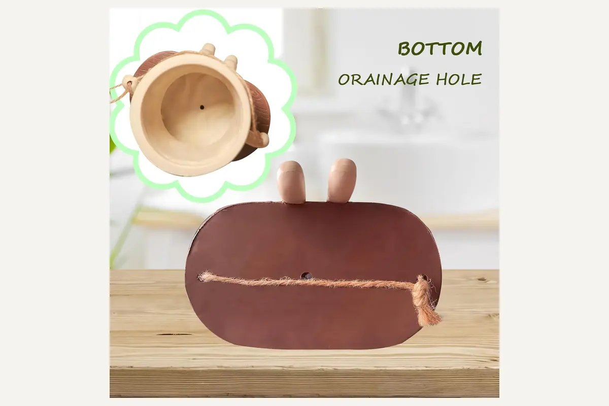 The underside drainage opening and swing base of a hanging planter