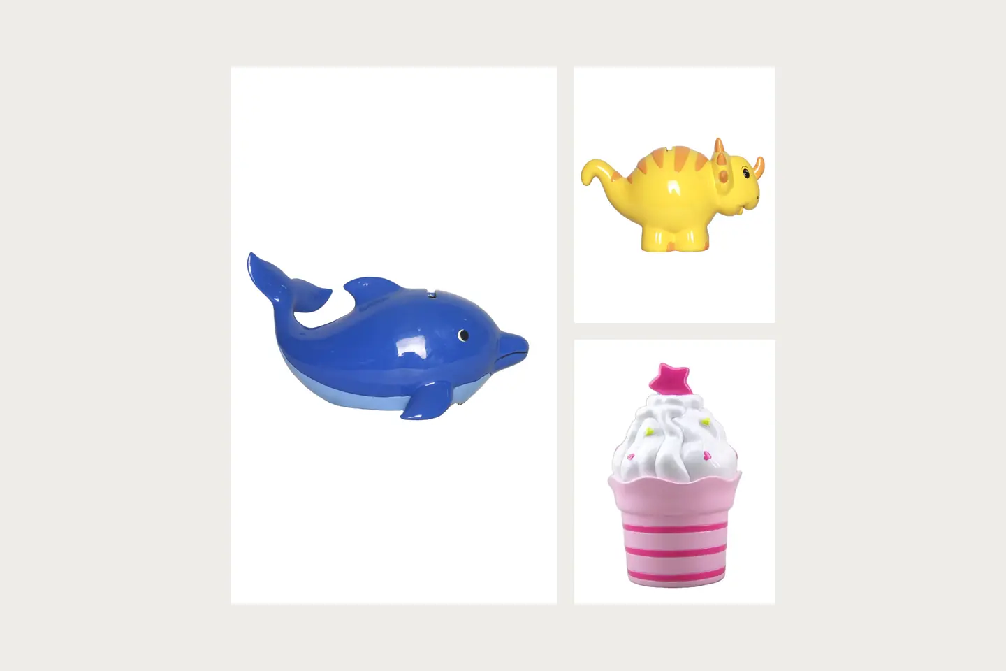 A glossy blue dolphin-shaped coin bank with a visible top slot; A yellow horned-dinosaur coin bank with orange back markings; A pink striped cupcake-shaped coin bank with a star decoration